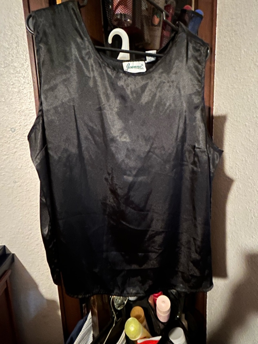 Joanna black tank blouse features a shiny, satin-like material.